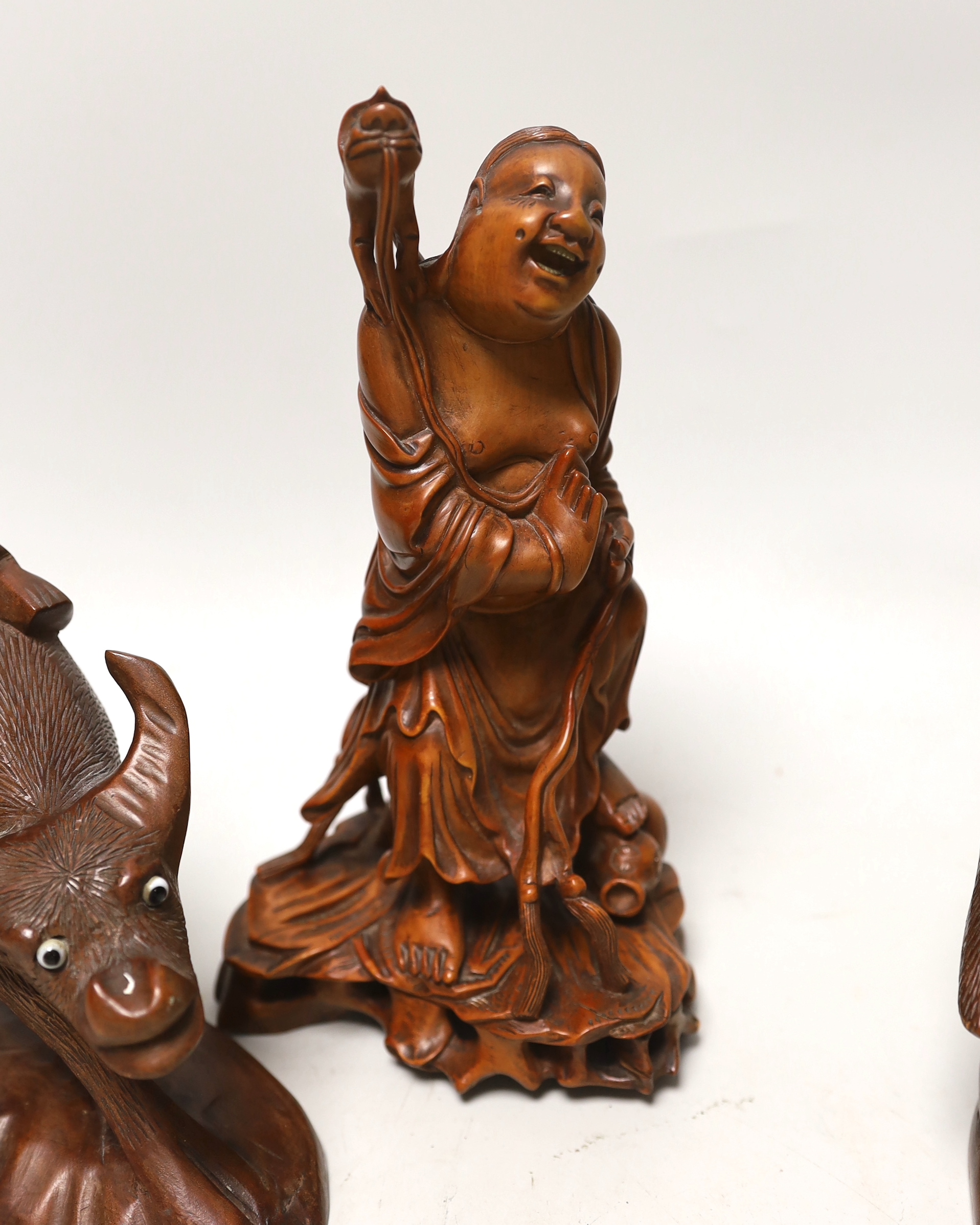 Three Chinese carved hardwood figures, tallest 23cm